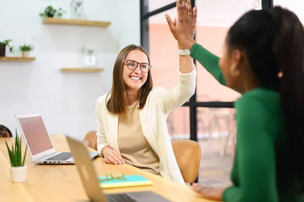 Two Young Happy Diverse Female Colleague Sitting Desk Taking High — Foto Stock