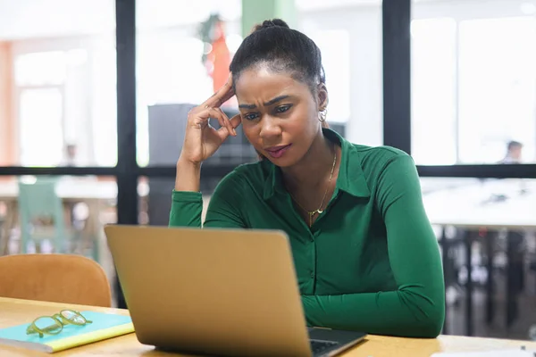 Thoughtful African American Female Office Employee Using Laptop Indoors Looking — Zdjęcie stockowe