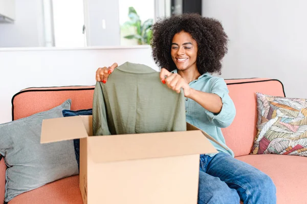 Cheerful Happy Multiracial Woman Unpack Cardboard Box Shipping Sitting Sofa — Stockfoto