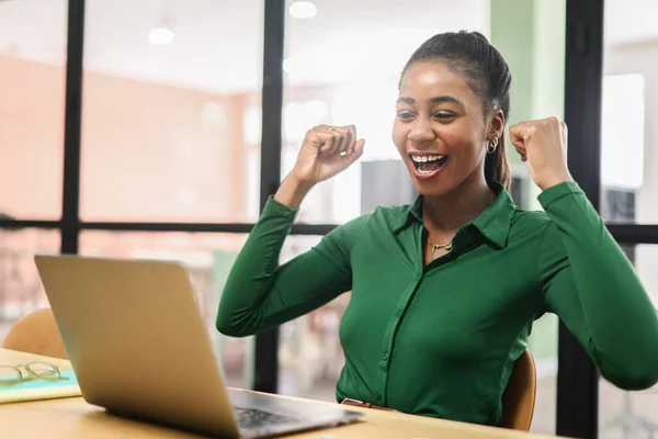 Happy Excited African American Woman Celebrating Victory Sitting Coworking Front — Stock fotografie