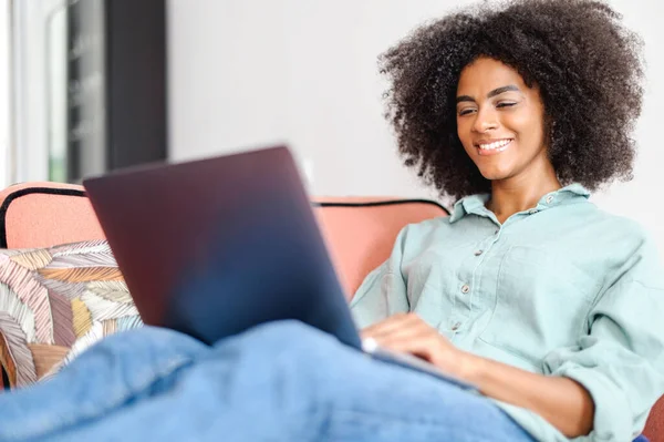 African Young Woman Student Freelancer Casual Wear Sitting Couch Using — Zdjęcie stockowe