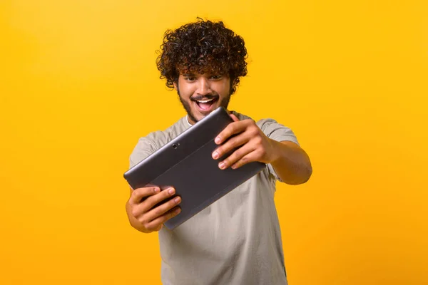 Handsome Curly Indian Man Holding Using Digital Tablet Excited Face — стоковое фото