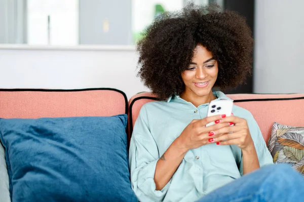 Positive Young Lady Sitting Relaxed Pose Comfortable Couch Smartphone Charming — Zdjęcie stockowe