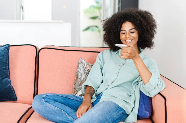 Young African Woman Sending Voice Message Recording Note Smartphone Sitting — Stockfoto