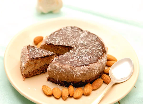 Roher veganer Kuchen in Scheiben geschnitten auf einem Gericht lizenzfreie Stockfotos