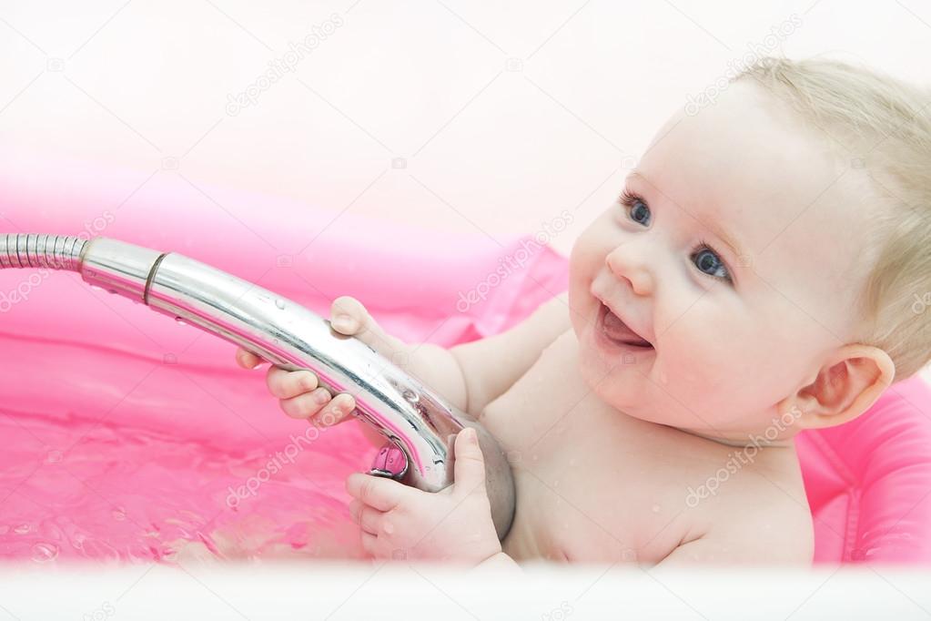 Happy baby in a bathtub