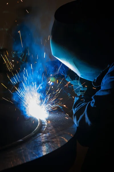 Welder worker is welding a big valve  body — Stock Photo, Image