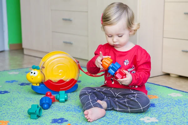 Little baby is playing with toys — Stock Photo, Image