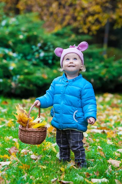 Laughing kid standing in an autumn park — Stock Photo, Image