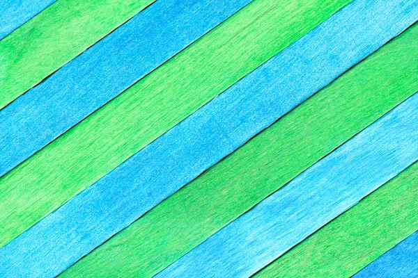 Alternating green and blue diagonal wood panels. Two-tones wooden textured background. Wooden boards are colored in blue and green.