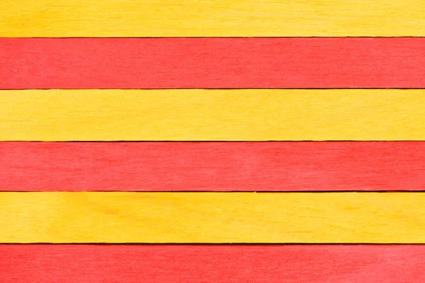 Vivid colorful red and yellow wood planks texture or background. Wooden textured background. Alternating red and yellow painted straight boards.
