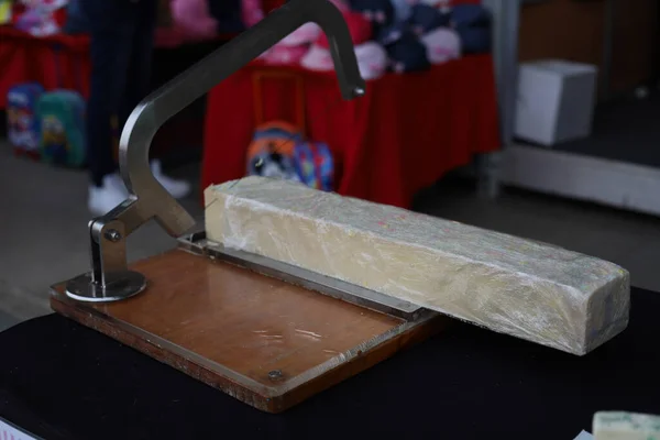 Handmade soap cutting in progress on table