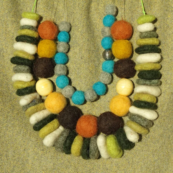 Three rows of handmade stylish colorful felt necklaces — Stock Photo, Image