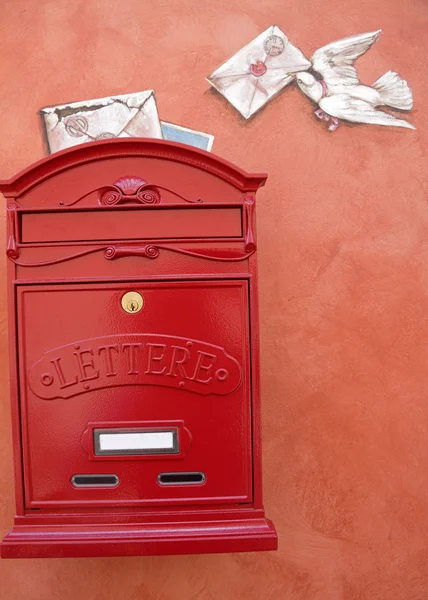 Red mailbox hanging on wall — Stock Photo, Image