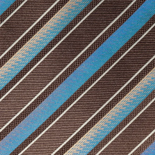 fabric with diagonal various widths blue , black and white stri