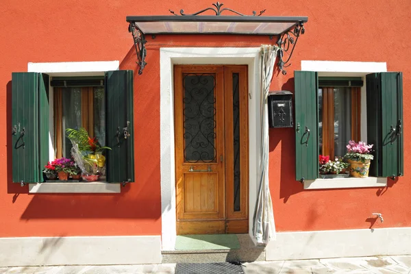 Entrance to the typical vivid painted house with small roof over — Stock Photo, Image