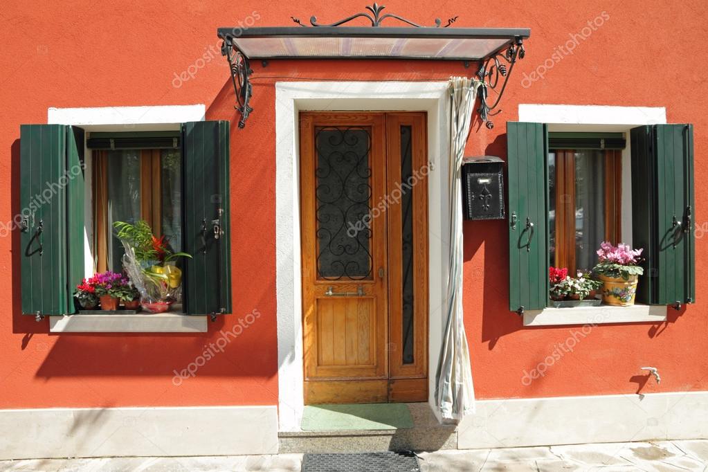 Entrance To The Typical Vivid Painted House With Small Roof