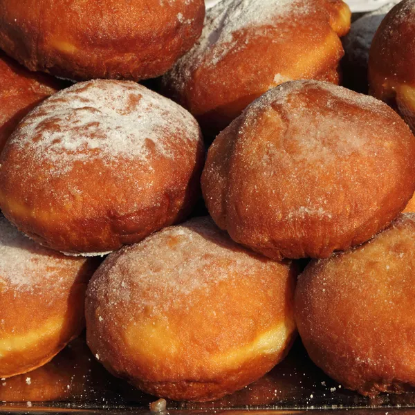 Deep fried doughnut covered with powdered sugar — Stock Photo, Image