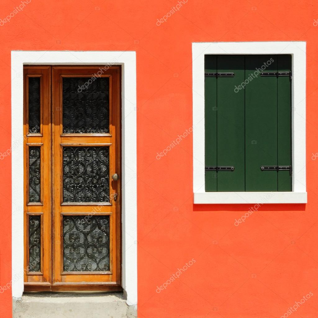 Front door in vivid orange painted house
