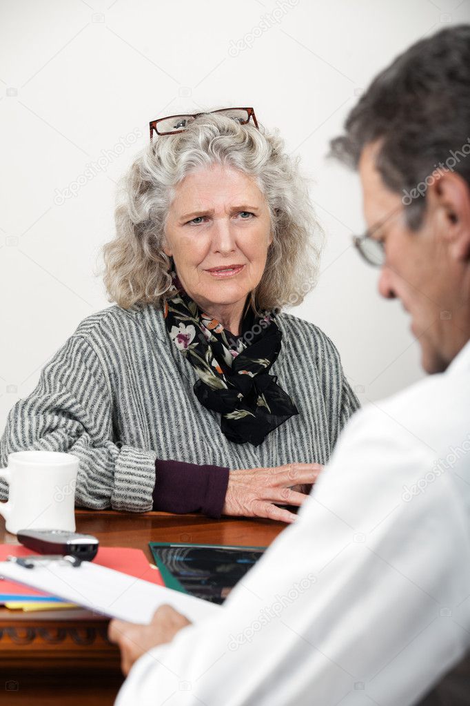 Worried Woman Talking with Her Doctor