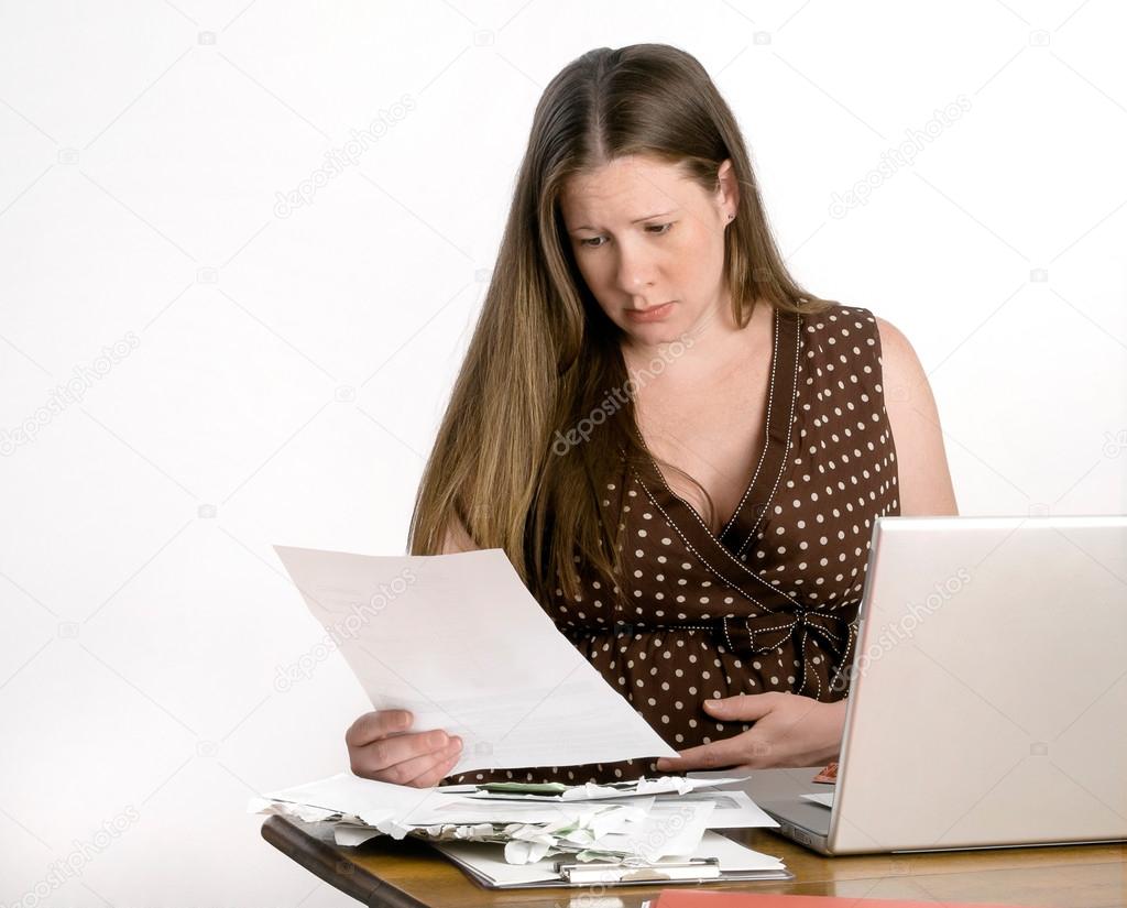 Pregnant Young Woman Reading Bills at Laptop Computer Looking Worried