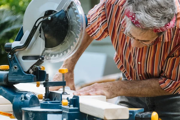 Man Sawing Wood with Sliding Compound Miter Saw Closeup — Stok Foto