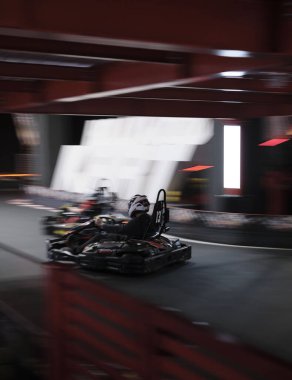 Electric Go kart speed race with two drivers in a indoor circuit race