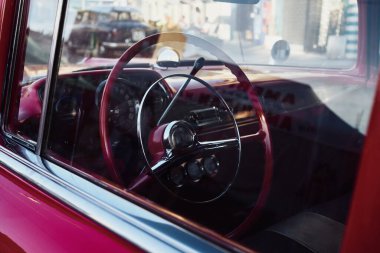 Retro car Cockpit parked in the old street of the European city.