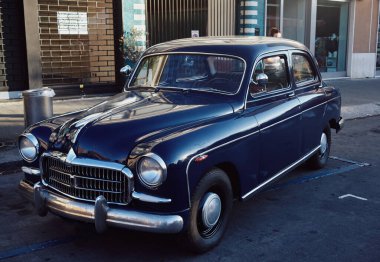 Italian Retro car parked in the old street of the European city