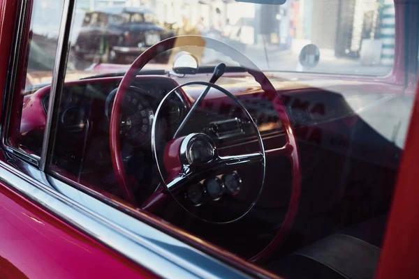 Retro car Cockpit parked in the old street of the European city.