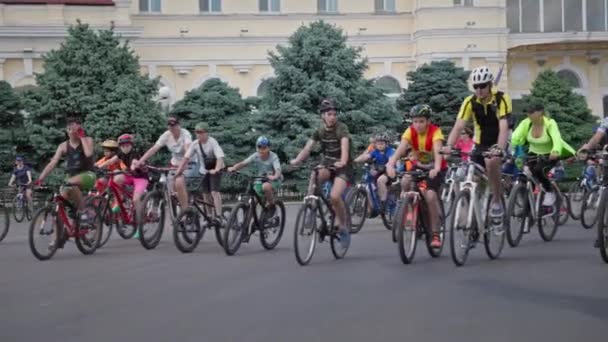 Херсон, Украина 10 августа 2021 года: велогонка, веселые юноши и девушки-подростки принимают участие в городском фестивале и катаются на велосипедах по дороге в летний день — стоковое видео