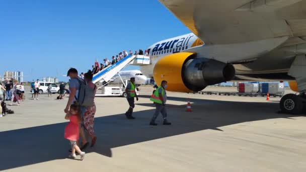 ANTALYA, TURKEY - LIPIEC 21, 2021: turyści przechodzą przez lotnisko, duży tłum pasażerów schodzi po schodach samolotu w zwolnionym tempie — Wideo stockowe