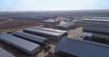 Köyde sığır ahırları olan büyük bir çiftliğin havadan görünüşü, tarım arazilerinin ve saman balyalarının yukarıdan görünüşü