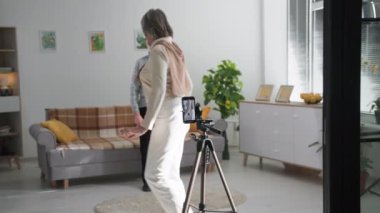 Son sınıfların hobileri, tapılası erkek ve kadın emekliler sosyal medya videolarını evin oturma odasında cep telefonu kamerasıyla çekerken eğleniyorlar.
