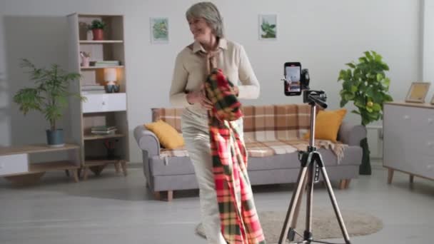 Bloggare, moderna pensionärer fotografera videoinnehåll för sociala nätverk och visa fokus på smartphone kamera i vardagsrummet — Stockvideo