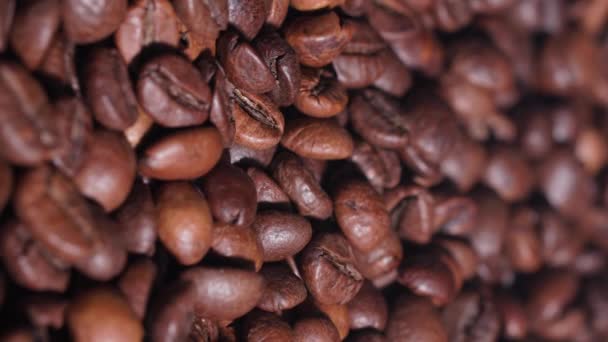 Hele geurige koffiebonen vallen tijdens het roosteren, close-up, verticaal formaat — Stockvideo