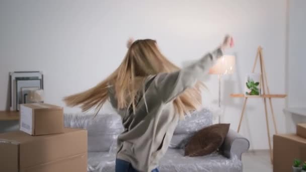 Alegre Chica Propietaria Nuevo Apartamento Está Saltando Bailando Activamente Una — Vídeos de Stock