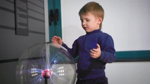 Happy Little Male Child Touching Plasma Ball Hand Creating Electric — стоковое видео
