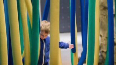 male child having fun playing with colored foam toys indoors