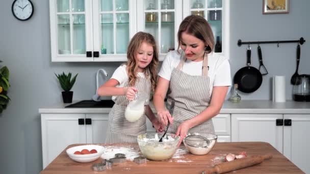 Motherhood Female Parent Cooks Dough Daughter Pours Milk Bowl While — Vídeo de stock