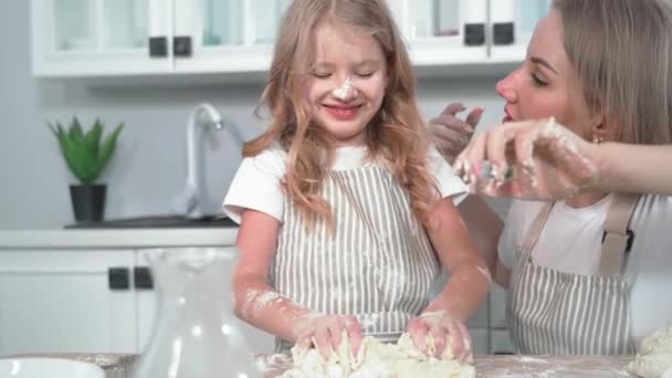 Loving Mom Blows Flour Daughter Dirty Face While Making Dough — Vídeo de stock