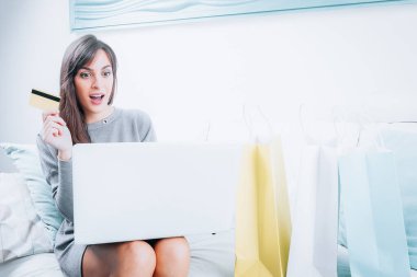 Young girl with laptop computer make a shopping closeup