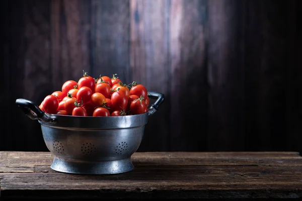 Fresh Red tomatoes box on wooden table. Close up