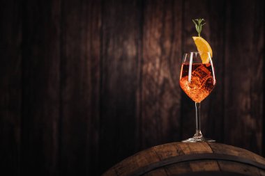A glass of spritz aperol cocktail decorated with orange on cellar close up