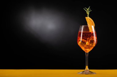 An Aperol Spritz with ice on the table close up