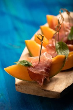 Cantaloupe melon with ham, a traditional appetizer close up