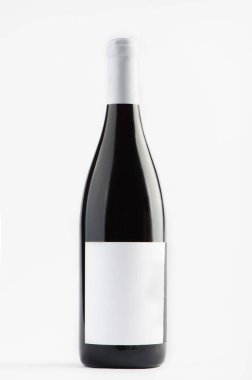 Red wine bottle with emty label isolated on a white background