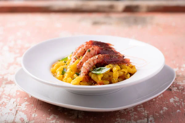 Busiate pasta with red shrimps from mazara del vallo served in a restaurant in Sicily Trapani. Sea Food Pasta