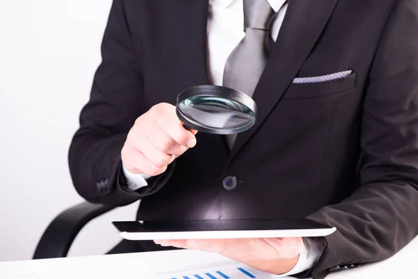 Auditor Holding Magnifying Glass Tablet Sitting Desk — Stockfoto