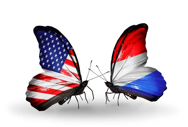 Two butterflies with flags on wings as symbol of relations USA and Luxembourg — Stock Photo, Image